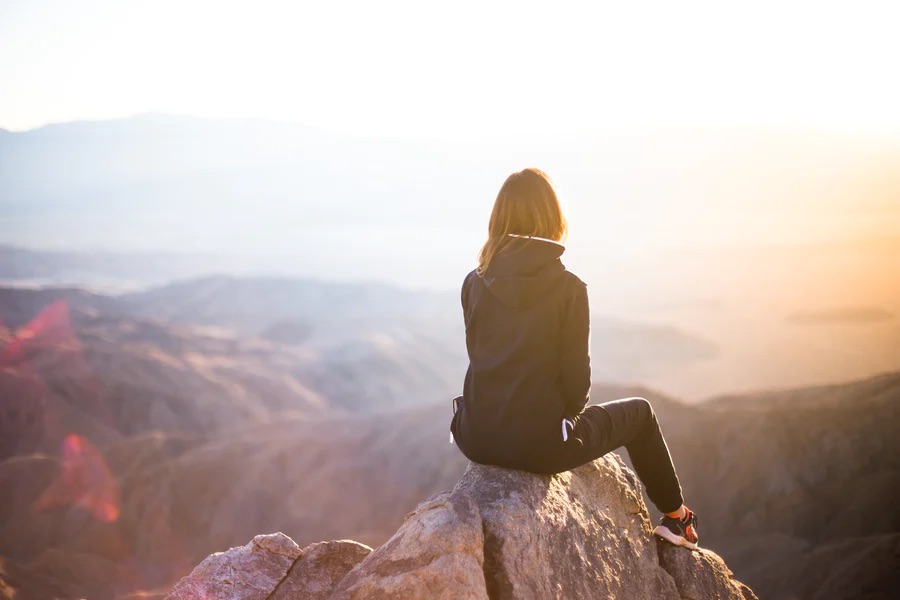 Woman looking at the view from a mountaintop